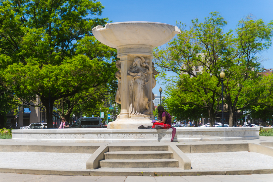 Person relaxing at Dupont Circle Monument 