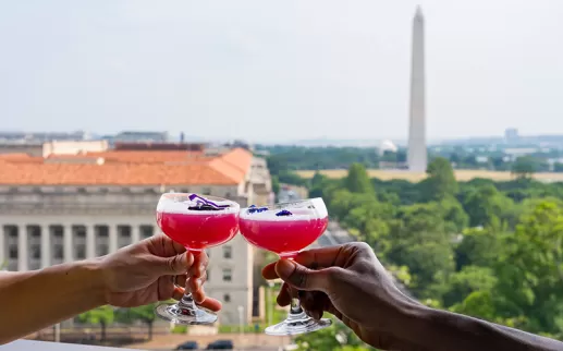 Drinks clinking on VUE Rooftop 
