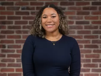 A woman smiles for a headshot. 
