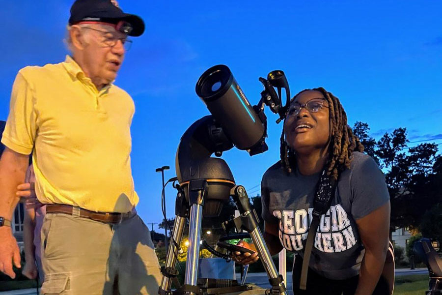 A person looking through a telescope while stargazing