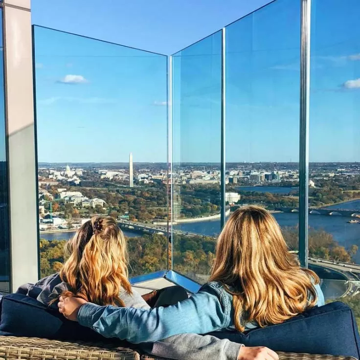 @annatheacook - Women at the top of the CEB Tower Observation Deck overlooking fall foliage in Washington, DC
