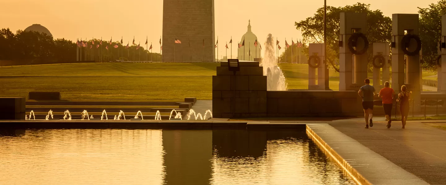 Group of people running beside Reflecting Pool on National Mall