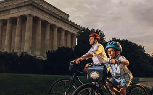 Family biking in front of Lincoln Memorial
